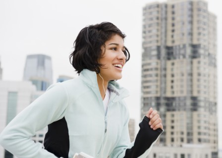 Hispanic woman running in city