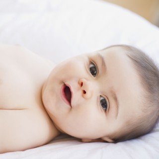 Mixed race baby boy smiling
