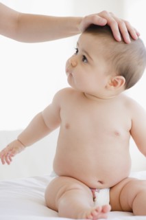 Mother comforting mixed race baby boy