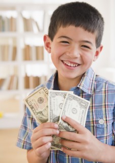 Mixed race boy holding money