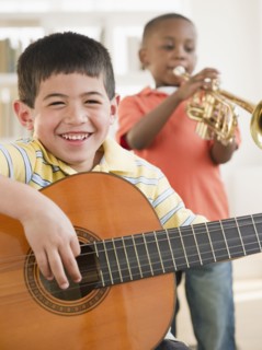 Boys playing trumpet and guitar