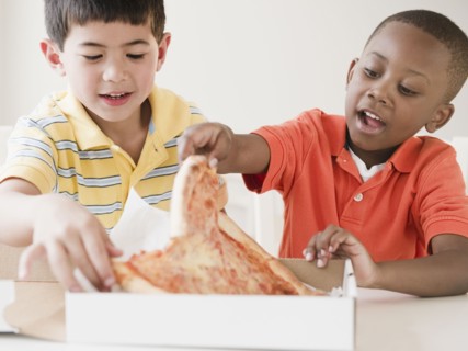 Boys eating pizza together