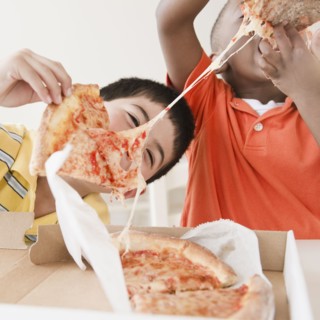 Boys eating pizza together