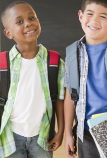Smiling boys wearing backpacks
