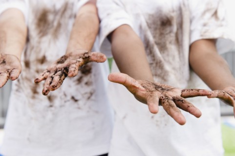 Boys displaying their messy hands