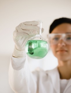 Mixed race researcher holding eco-friendly beaker
