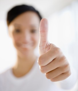 Mixed race woman giving thumbs up sign
