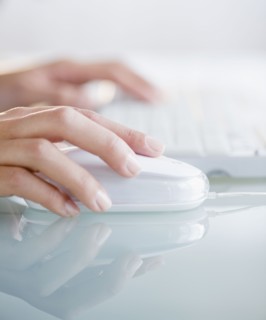 Hands operating computer mouse and keyboard