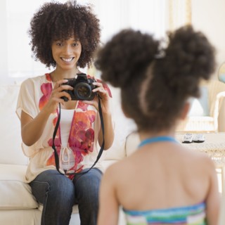 Mother photographing daughter