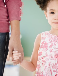 Woman and girl holding hands