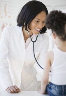 Pediatrician with stethoscope examining patient