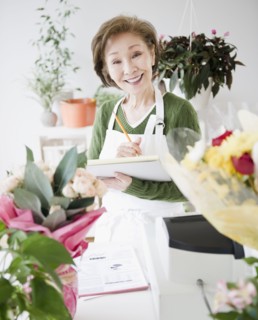 Japanese florist writing on notepad