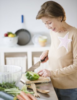 Japanese woman preparing vegetables in kitchen