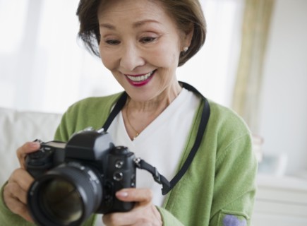 Japanese woman holding digital camera