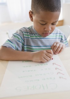 African American boy checking list of chores