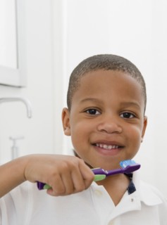 African American boy brushing teeth