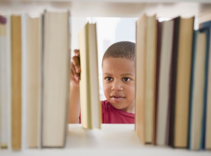 African American boy selecting book
