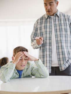 Hispanic father lecturing frustrated son