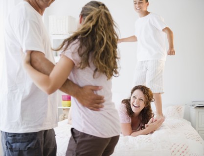 Laughing Hispanic family playing together