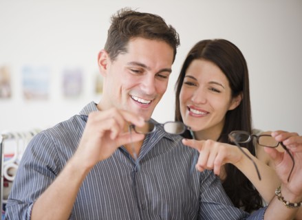 Smiling couple shopping for eyeglasses together