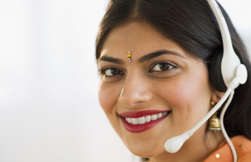 Indian woman in traditional Indian clothing talking on headset