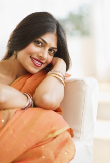Indian woman in traditional Indian clothing sitting in chair