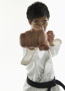 Asian male karate black belt punching