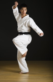 Asian male black belt practicing karate