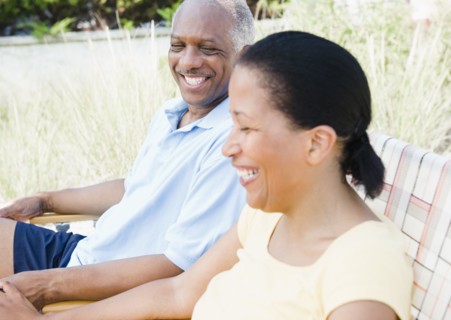 Black couple laughing outdoors together