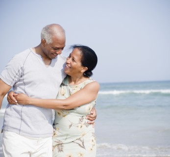Black couple enjoying beach together
