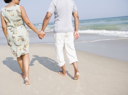 Black couple enjoying beach together