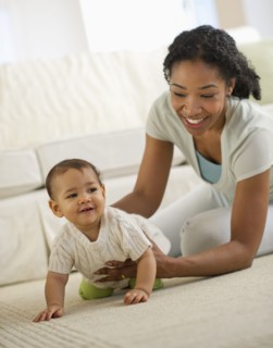 Mixed race mother playing with baby