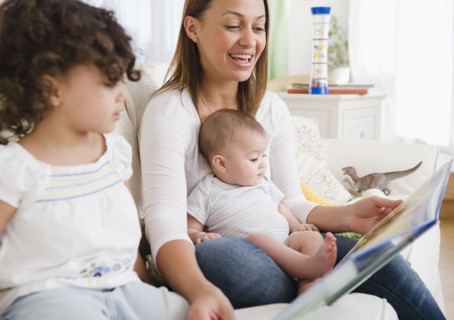 Mother reading daughters storybook