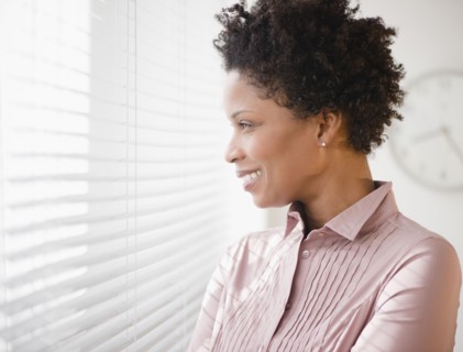 Black businesswoman looking out window
