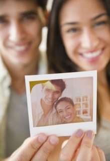 Couple holding photograph of themselves