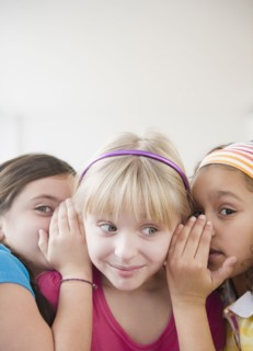 Girls whispering together