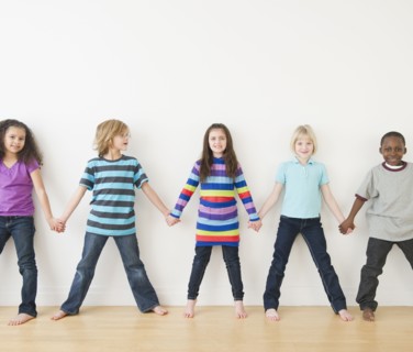 Friends holding hands in a row