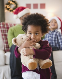 Black girl hugging teddy bear