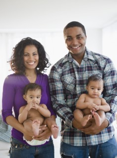 Parents holding twin baby boys