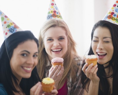 Friends eating cupcakes at birthday party