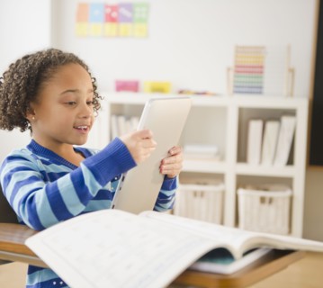 African American girl looking at digital tablet