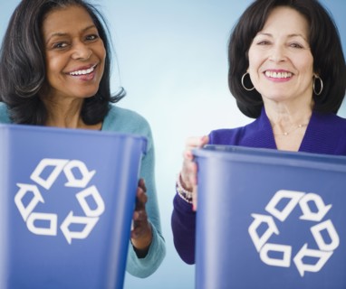 Friends carrying recycling bins