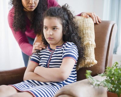 Mother comforting stubborn daughter