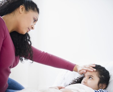 Mother checking daughter's fever