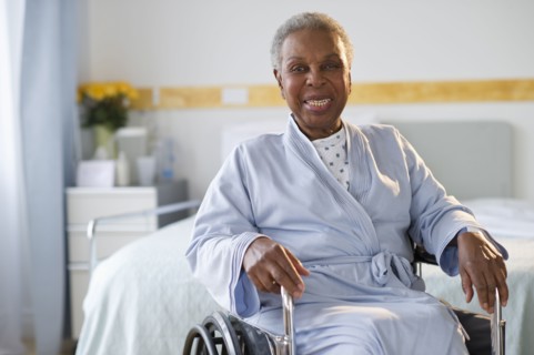 Black woman sitting in wheelchair in  hospital