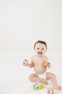 Mixed race baby playing with alphabet blocks