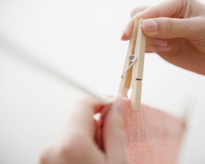 Korean woman hanging clothing on clothes line