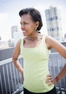 Black woman on urban balcony