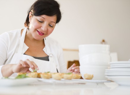 Smiling Hispanic woman baking