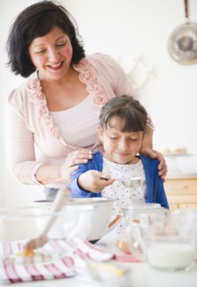 Hispanic mother and daughter baking together